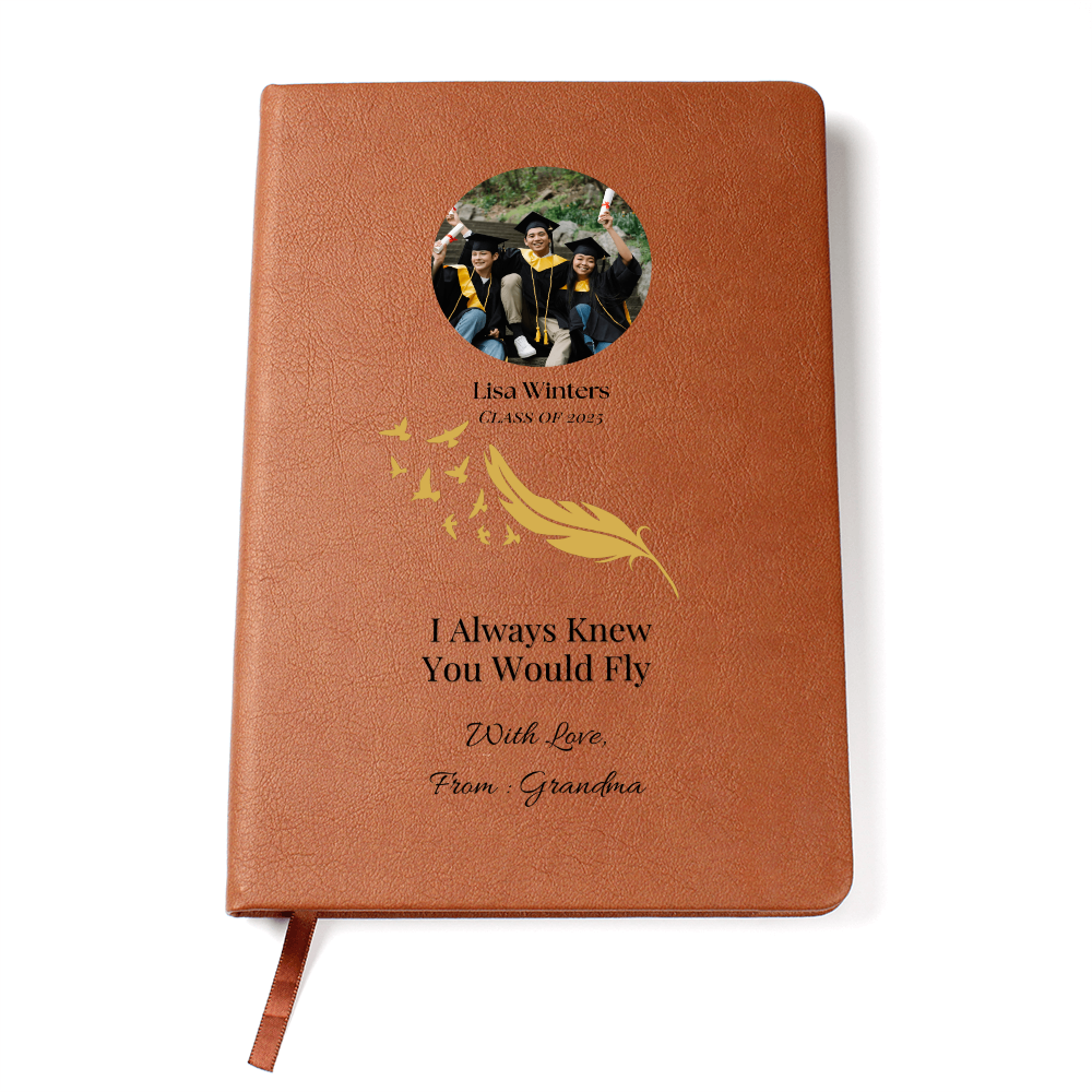 Personalized graduation journal with leather cover, gold feather design, custom photo, name “Lisa Winters,” and quote “I Always Knew You Would Fly” from Grandma.